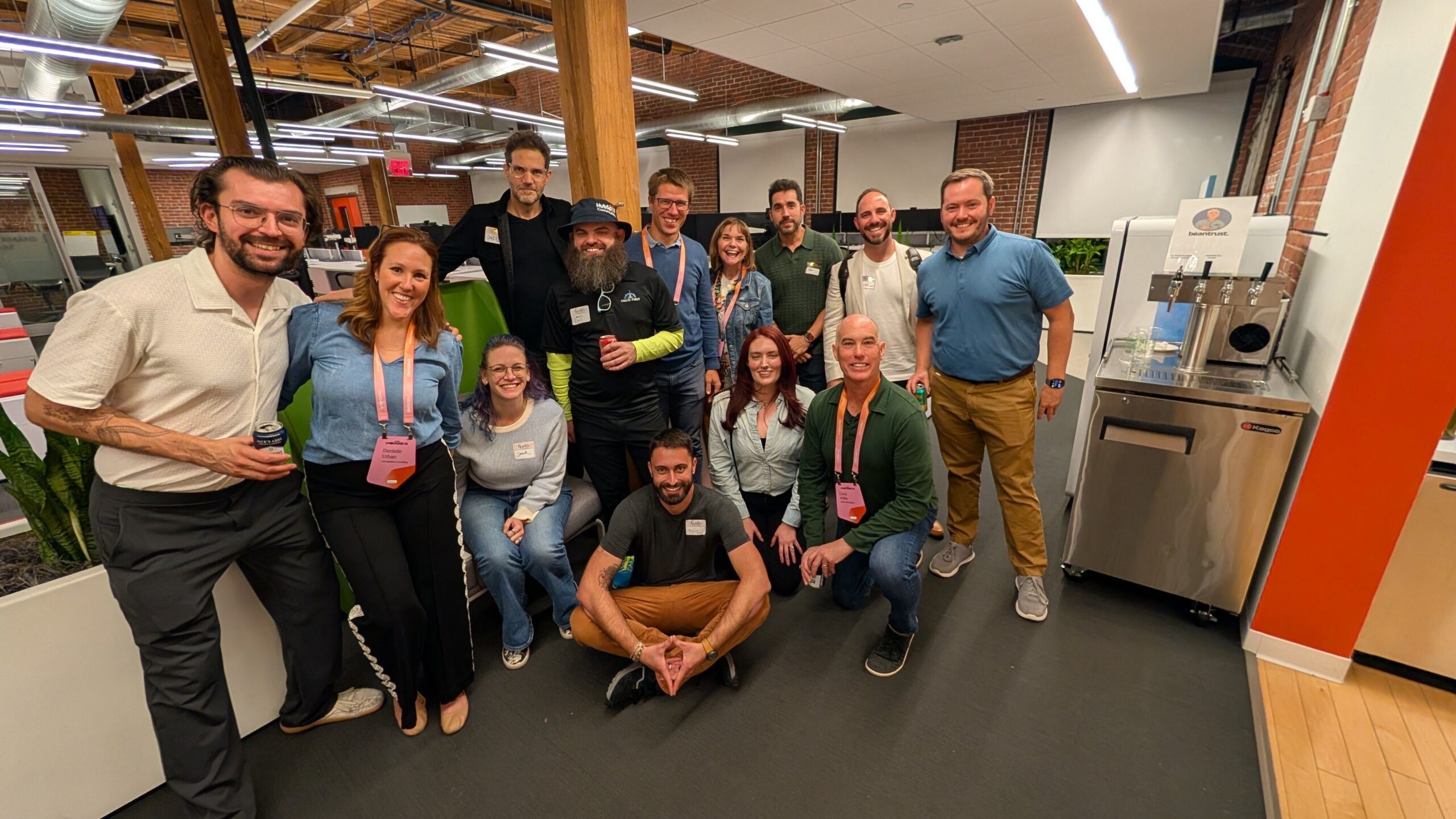 A group of guests smiling together at the Unbound kickoff party in GoTo's Boston office