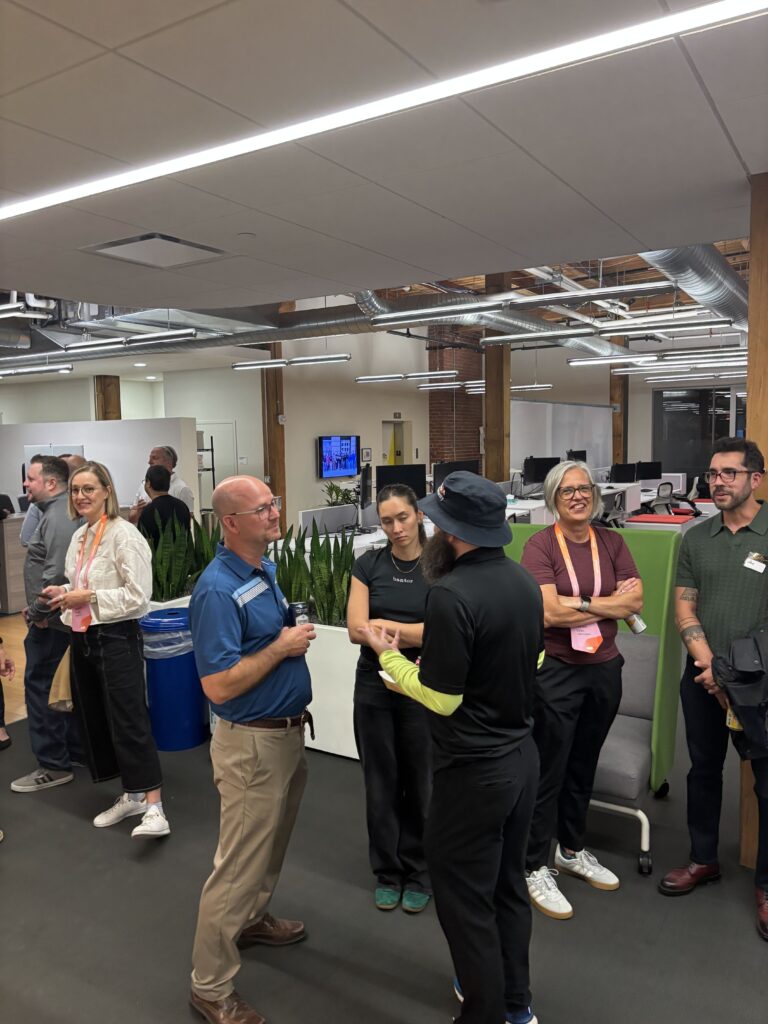 A small group deep in conversation in the open office