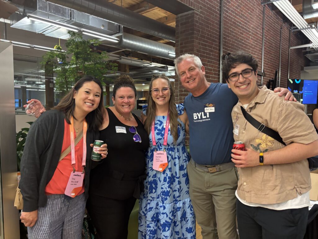 Five guests posing together with their Unbound badges