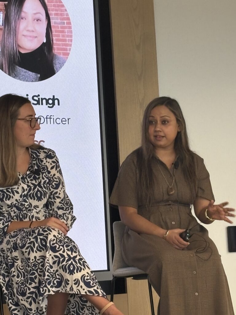 Sumi Singh speaking during the panel while Emma Harney listens