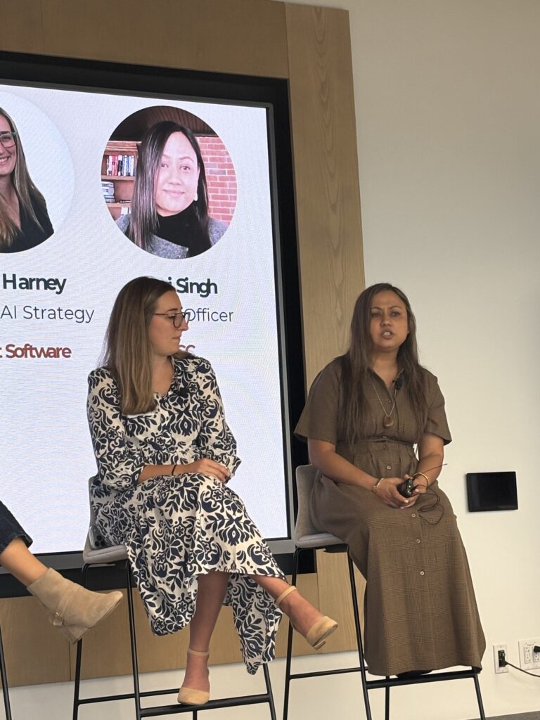 Emma Harney and Sumi Singh seated on stage during the panel discussion
