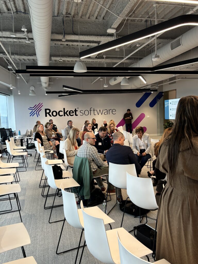 The full room at Rocket Software split into small roundtable groups